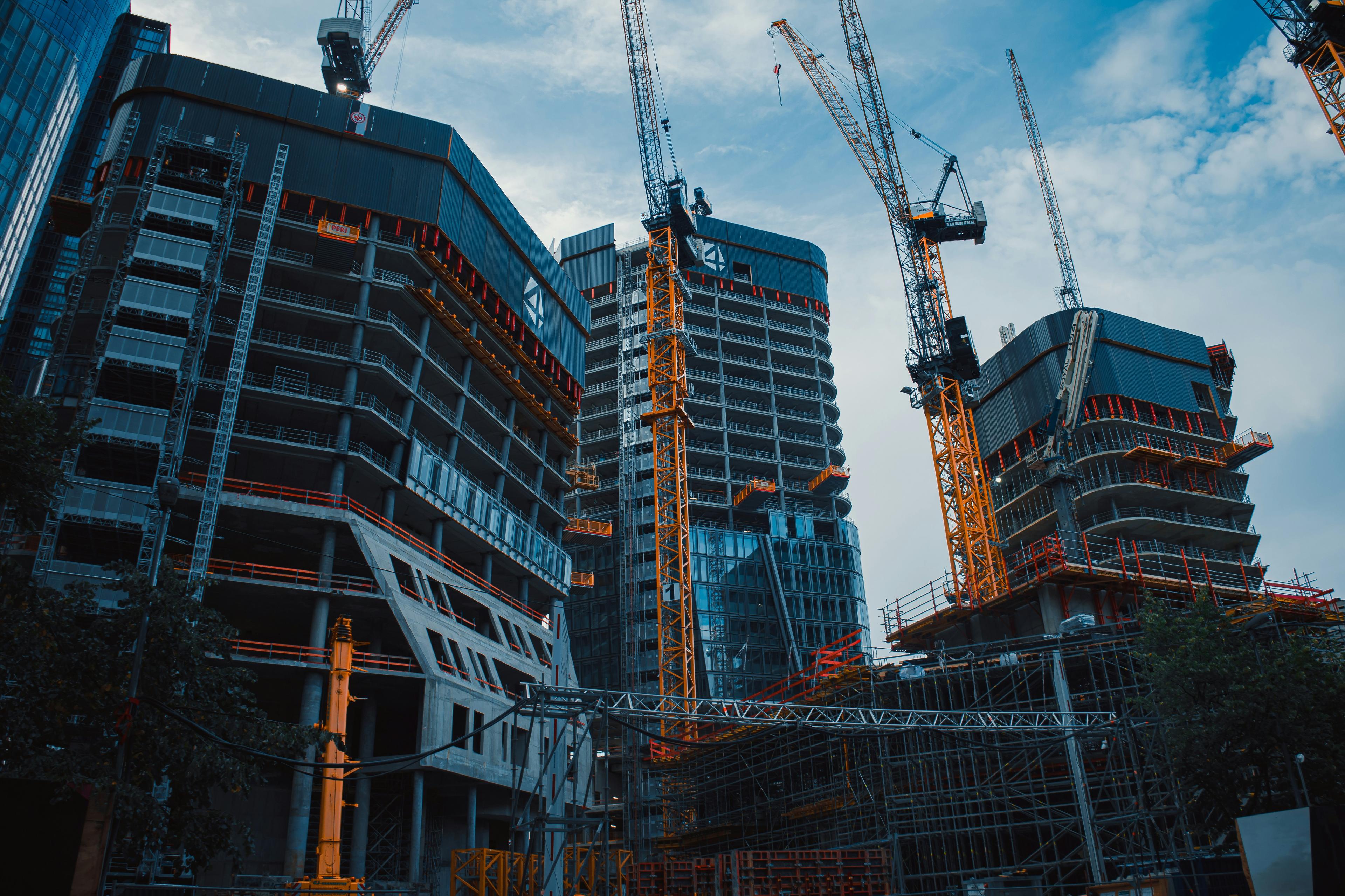 Construction of a modern building with cranes and scaffolding